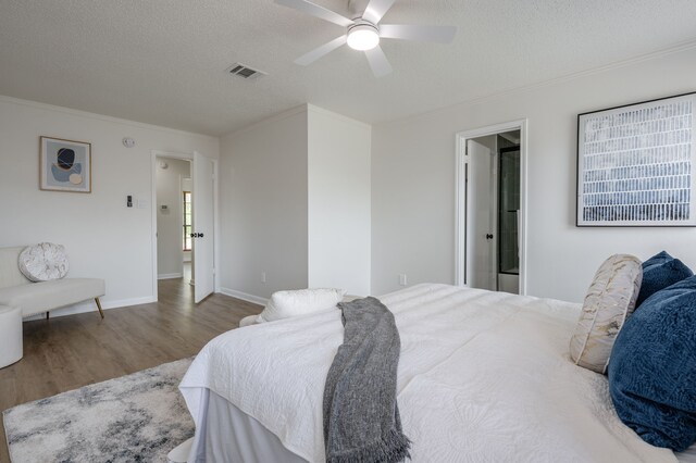 2508 Independence Dr, Mesquite, TX 75150 - bedroom featuring wood finished floors, a textured ceiling, crown molding, ceiling fan, and ensuite bathroom