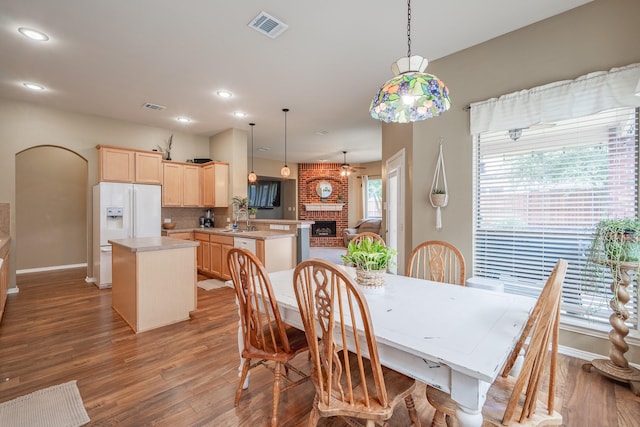 134 Fox Hollow Blvd, Forney, TX 75126 - dining space featuring wood finished floors, recessed lighting, a brick fireplace, and ceiling fan