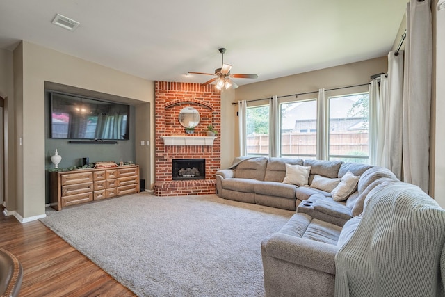 134 Fox Hollow Blvd, Forney, TX 75126 - living room with ceiling fan, wood finished floors, and a fireplace