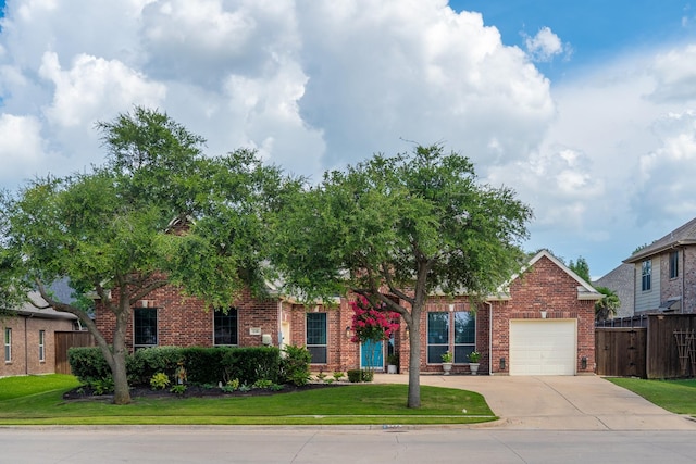 134 Fox Hollow Blvd, Forney, TX 75126 - view of property hidden behind natural elements with brick siding, an attached garage, and driveway