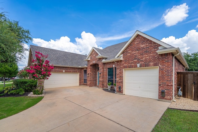 134 Fox Hollow Blvd, Forney, TX 75126 - traditional-style house with driveway, brick siding, a shingled roof, and a garage