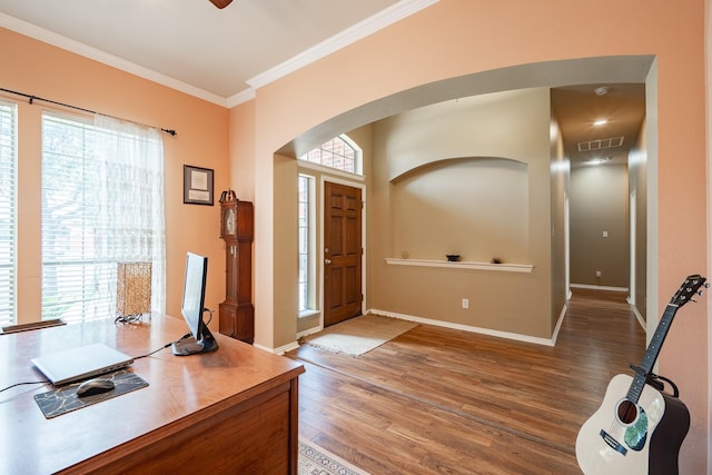 134 Fox Hollow Blvd, Forney, TX 75126 - foyer entrance featuring arched walkways, wood finished floors, and crown molding