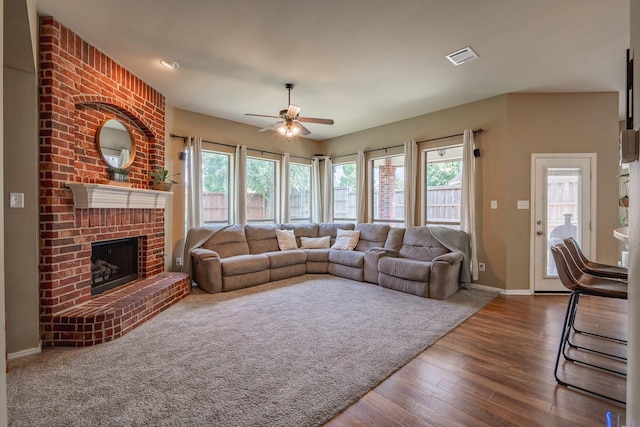 134 Fox Hollow Blvd, Forney, TX 75126 - living room featuring ceiling fan, healthy amount of natural light, dark wood-style floors, and a fireplace