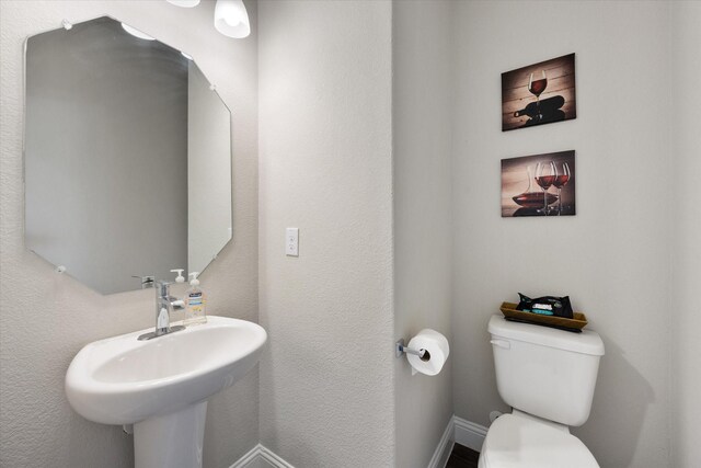 3703 Twin Pines Dr, Grand Prairie, TX 76065 - half bath featuring toilet and a sink