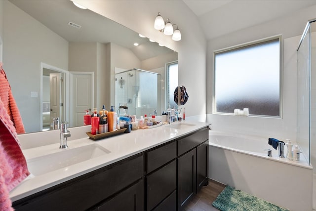 3703 Twin Pines Dr, Grand Prairie, TX 76065 - bathroom with a stall shower, double vanity, a bath, wood finished floors, and lofted ceiling