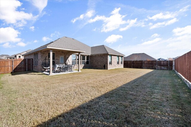 3703 Twin Pines Dr, Grand Prairie, TX 76065 - rear view of house featuring brick siding, a fenced backyard, and a patio