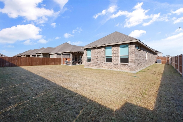 3703 Twin Pines Dr, Grand Prairie, TX 76065 - rear view of house featuring brick siding, a fenced backyard, and roof with shingles