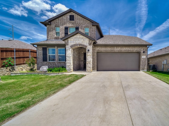 1701 Briar Hill Dr, Denton, TX 76207 - view of front of property with brick siding, a garage, driveway, a shingled roof, and stone siding