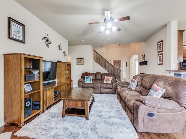1314 Merrimac Dr, Allen, TX 75002 - living area featuring arched walkways, stairs, ceiling fan, and wood finished floors