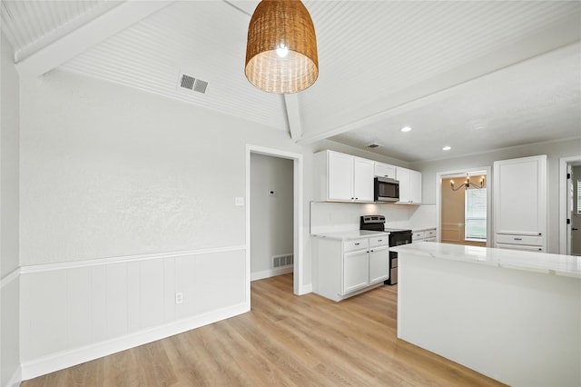 3505 Scott Dr, Rowlett, TX 75088 - kitchen featuring range with electric stovetop, stainless steel microwave, a chandelier, light wood-style flooring, and white cabinets