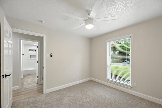 3505 Scott Dr, Rowlett, TX 75088 - empty room featuring a textured ceiling, a ceiling fan, light colored carpet, and a smoke detector