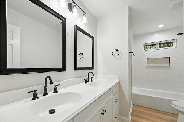 3505 Scott Dr, Rowlett, TX 75088 - bathroom featuring double vanity, wood finished floors, and  shower combination