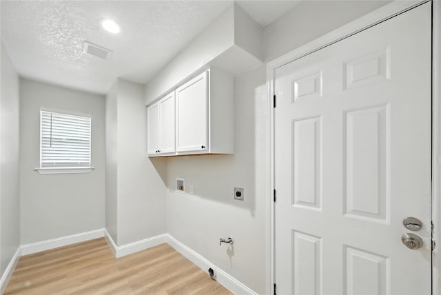 3505 Scott Dr, Rowlett, TX 75088 - laundry room with hookup for a washing machine, hookup for an electric dryer, light wood-type flooring, gas dryer hookup, and cabinet space