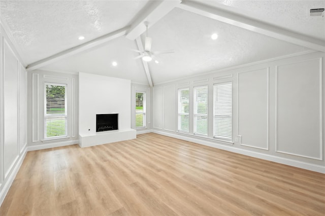 3505 Scott Dr, Rowlett, TX 75088 - unfurnished living room featuring a decorative wall, ceiling fan, a fireplace with raised hearth, light wood-style floors, and recessed lighting