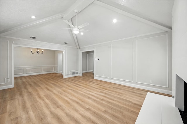3505 Scott Dr, Rowlett, TX 75088 - unfurnished living room featuring a decorative wall, ceiling fan, a chandelier, and light wood finished floors
