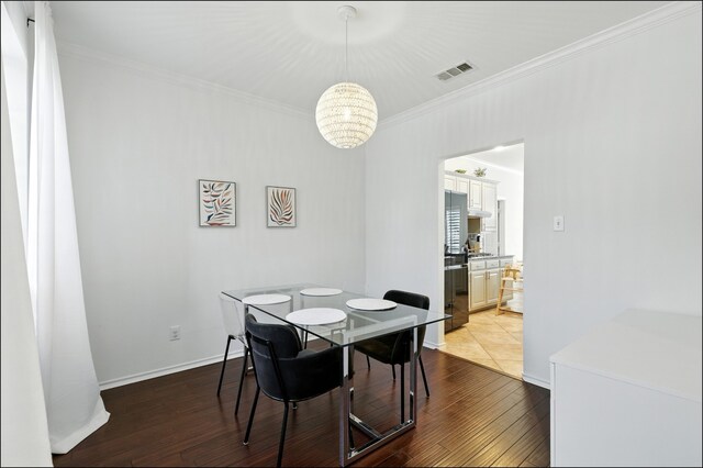 1604 Tree Line Rd, Flower Mound, TX 75028 - dining area with a chandelier, crown molding, and wood-type flooring
