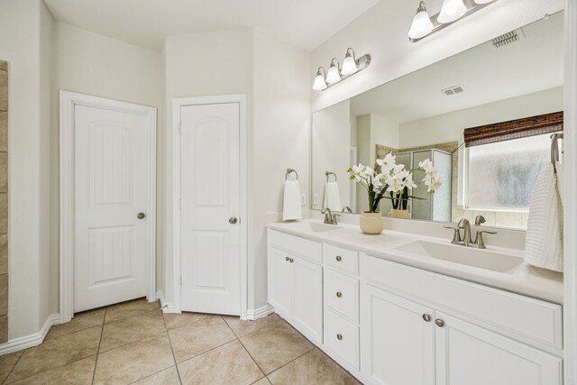 1012 Rising Moon Dr, Fort Worth, TX 76052 - bathroom with double vanity, tile patterned flooring, and tiled shower