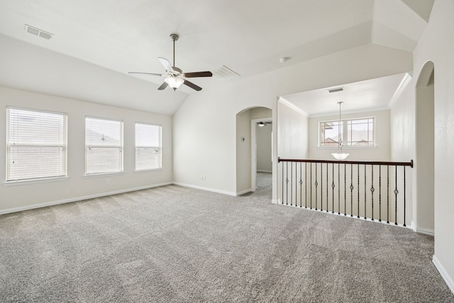 1012 Rising Moon Dr, Fort Worth, TX 76052 - empty room featuring ceiling fan, arched walkways, carpet, healthy amount of natural light, and crown molding