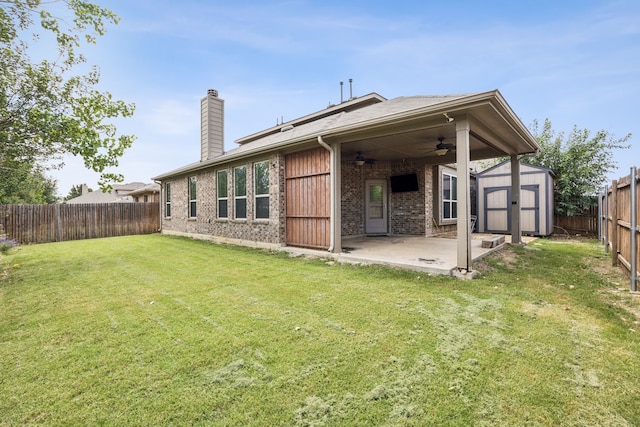 1012 Rising Moon Dr, Fort Worth, TX 76052 - back of house featuring a ceiling fan, a storage unit, a fenced backyard, a patio, and a chimney