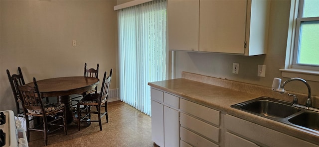 1747 Lucille Dr, Mesquite, TX 75149 - kitchen with white cabinetry, tile patterned floors, and stove