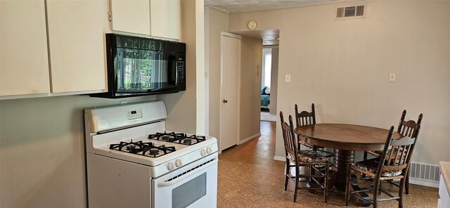 1747 Lucille Dr, Mesquite, TX 75149 - kitchen with white range with gas cooktop and black microwave