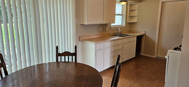 1747 Lucille Dr, Mesquite, TX 75149 - kitchen with white range, dark floors, white cabinetry, light countertops, and open shelves