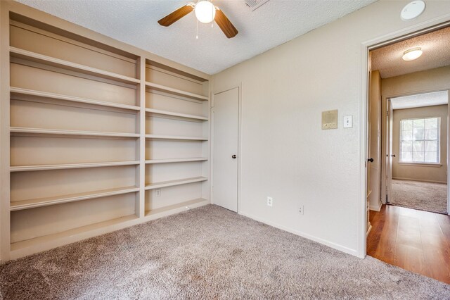 304 Mack Dr, Denton, TX 76209 - unfurnished bedroom with carpet, a textured ceiling, and ceiling fan