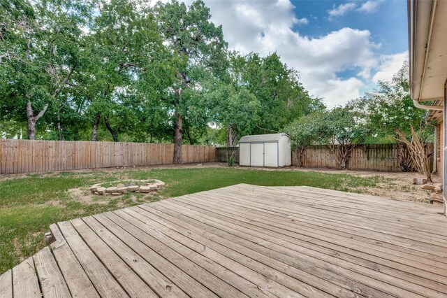 304 Mack Dr, Denton, TX 76209 - wooden deck featuring a fenced backyard and a storage unit