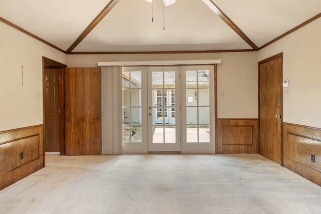 10009 Apple Creek Dr, Dallas, TX 75243 - empty room featuring a wainscoted wall, ornamental molding, carpet, lofted ceiling, and a ceiling fan
