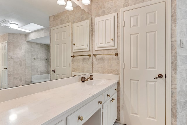 10009 Apple Creek Dr, Dallas, TX 75243 - full bathroom featuring vanity and tile walls