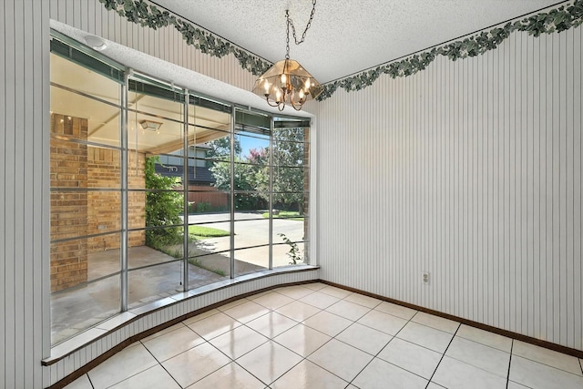 233 Hillview Dr, Hurst, TX 76054 - unfurnished dining area featuring a chandelier, wallpapered walls, and a textured ceiling