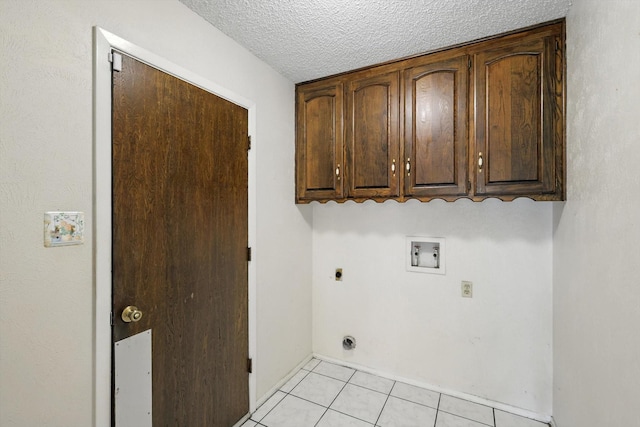 233 Hillview Dr, Hurst, TX 76054 - washroom featuring hookup for a washing machine, hookup for an electric dryer, cabinet space, light tile patterned floors, and a textured ceiling