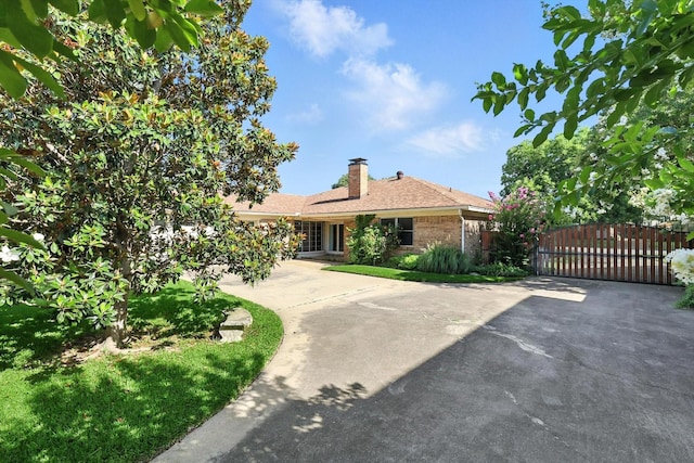 233 Hillview Dr, Hurst, TX 76054 - single story home with a gate, a chimney, driveway, and brick siding