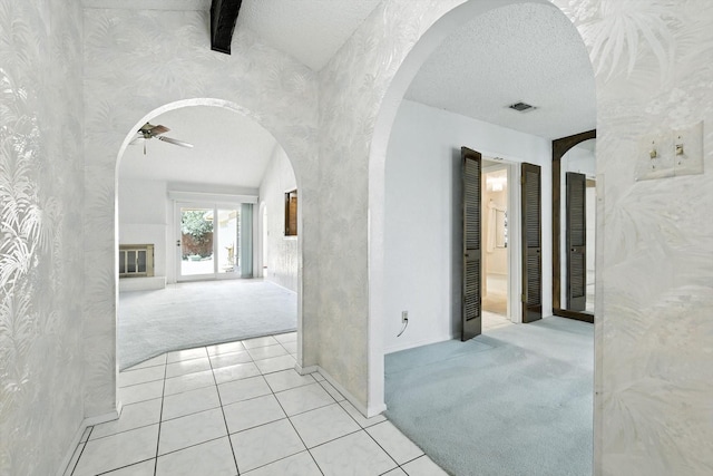 233 Hillview Dr, Hurst, TX 76054 - corridor featuring carpet flooring, arched walkways, wallpapered walls, and tile patterned floors