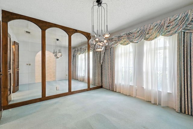 233 Hillview Dr, Hurst, TX 76054 - empty room with carpet, a chandelier, and a textured ceiling