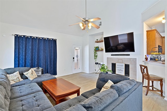 10027 Hanover Dr, Providence Village, TX 76227 - living area featuring light wood finished floors, a ceiling fan, a fireplace, and lofted ceiling
