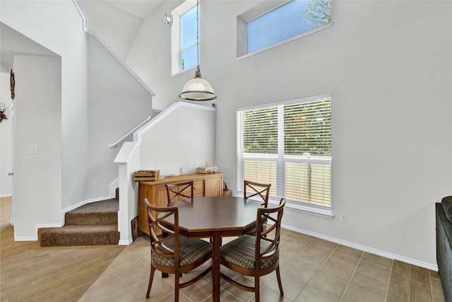 10027 Hanover Dr, Providence Village, TX 76227 - dining area featuring a towering ceiling and stairs