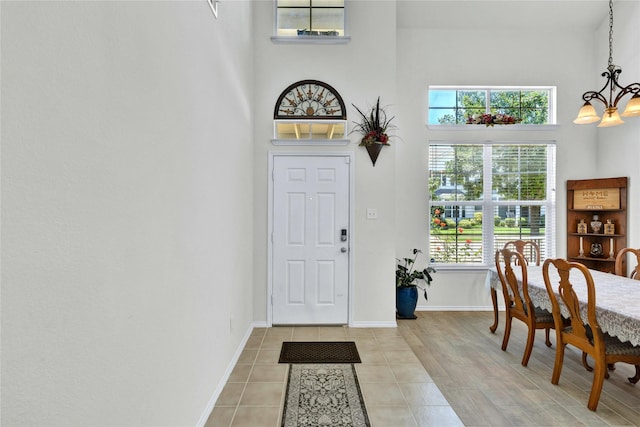 10027 Hanover Dr, Providence Village, TX 76227 - entrance foyer featuring a chandelier, a high ceiling, and light tile patterned floors