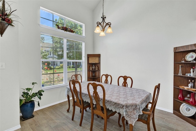 10027 Hanover Dr, Providence Village, TX 76227 - dining area featuring healthy amount of natural light, wood finished floors, a high ceiling, and a chandelier