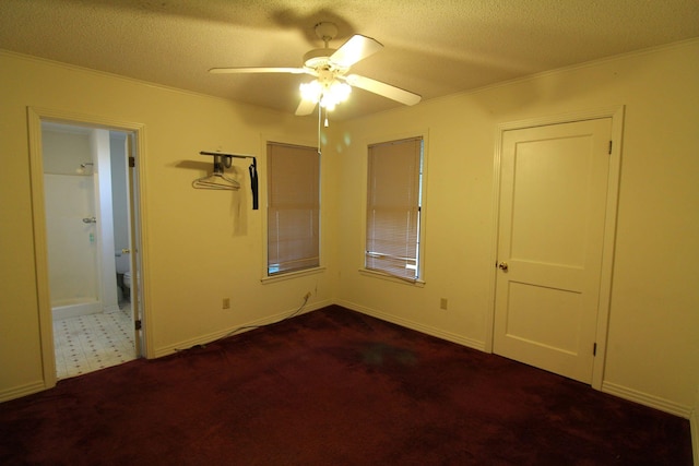 1 Mason St, Minden, LA 71055 - unfurnished bedroom with a textured ceiling, dark colored carpet, ornamental molding, ensuite bathroom, and a ceiling fan