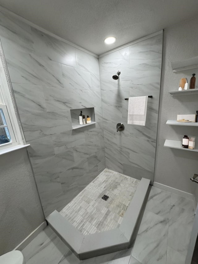 8718 Greenmound Ave, Dallas, TX 75227 - bathroom featuring marble finish floors, tiled shower, a textured ceiling, and recessed lighting