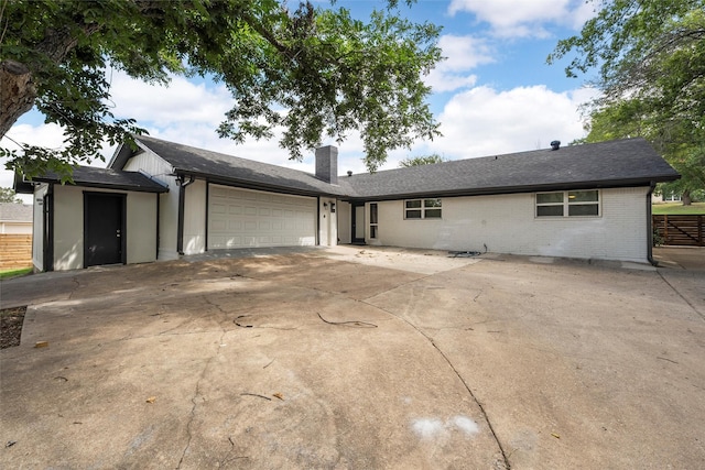1132 Western Oaks Dr, Woodway, TX 76712 - ranch-style home featuring a chimney, a garage, concrete driveway, and brick siding