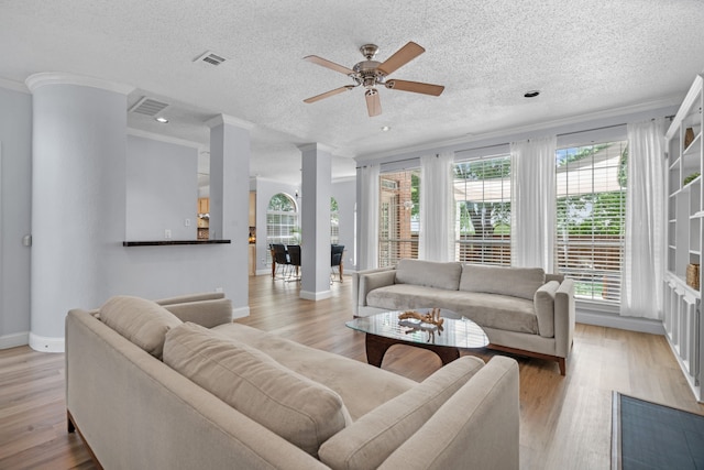 8347 Mountainview Dr, Dallas, TX 75249 - living room with a ceiling fan, light wood-type flooring, a textured ceiling, ornamental molding, and recessed lighting