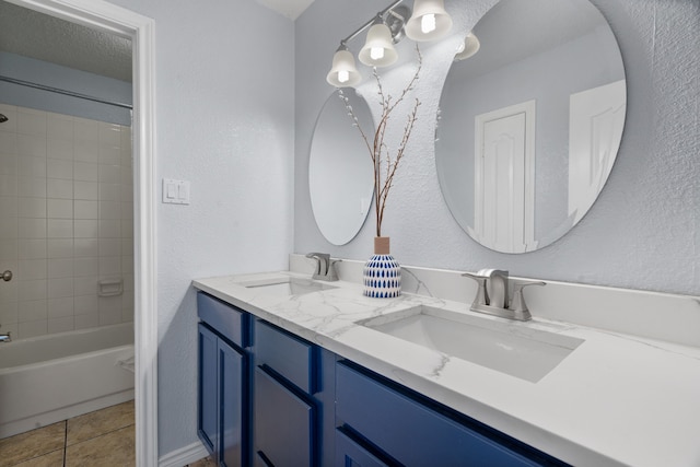 8347 Mountainview Dr, Dallas, TX 75249 - full bath with a textured wall, double vanity,  shower combination, and tile patterned flooring