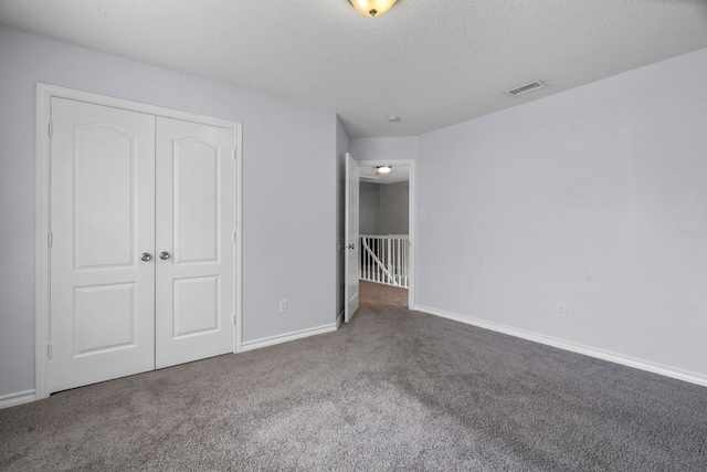 8347 Mountainview Dr, Dallas, TX 75249 - unfurnished bedroom with carpet flooring, a closet, and a textured ceiling
