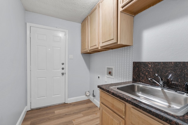 8347 Mountainview Dr, Dallas, TX 75249 - washroom featuring hookup for a washing machine, cabinet space, light wood-style floors, electric dryer hookup, and a textured ceiling