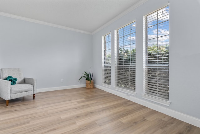 8347 Mountainview Dr, Dallas, TX 75249 - sitting room featuring crown molding and light wood-style floors