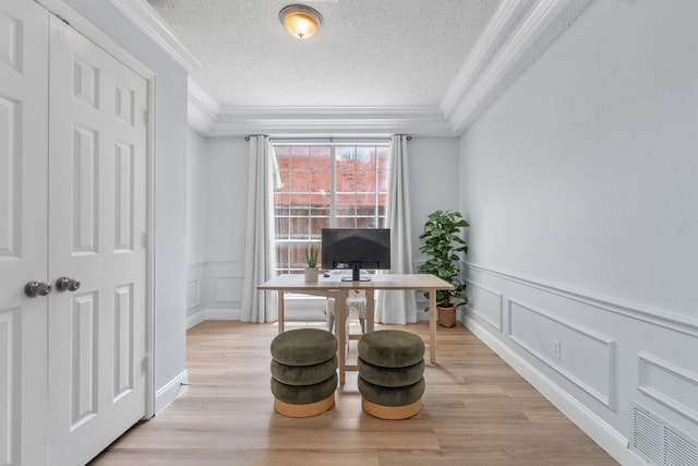 8347 Mountainview Dr, Dallas, TX 75249 - office featuring a decorative wall, crown molding, a textured ceiling, light wood-style flooring, and wainscoting