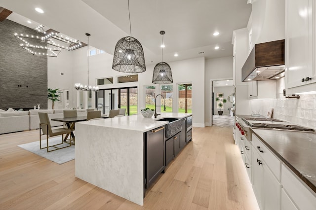 1732 Oakbrook Dr, Keller, TX 76262 - kitchen with stainless steel gas stovetop, a towering ceiling, light wood-style flooring, recessed lighting, and white cabinetry