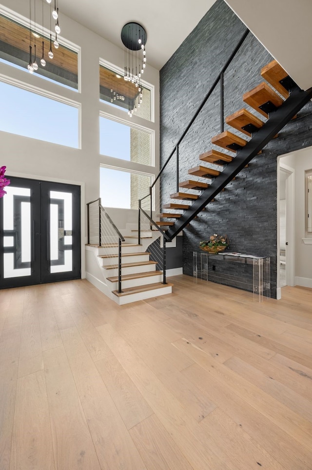 1732 Oakbrook Dr, Keller, TX 76262 - entrance foyer with a high ceiling, stairway, wood-type flooring, a chandelier, and french doors